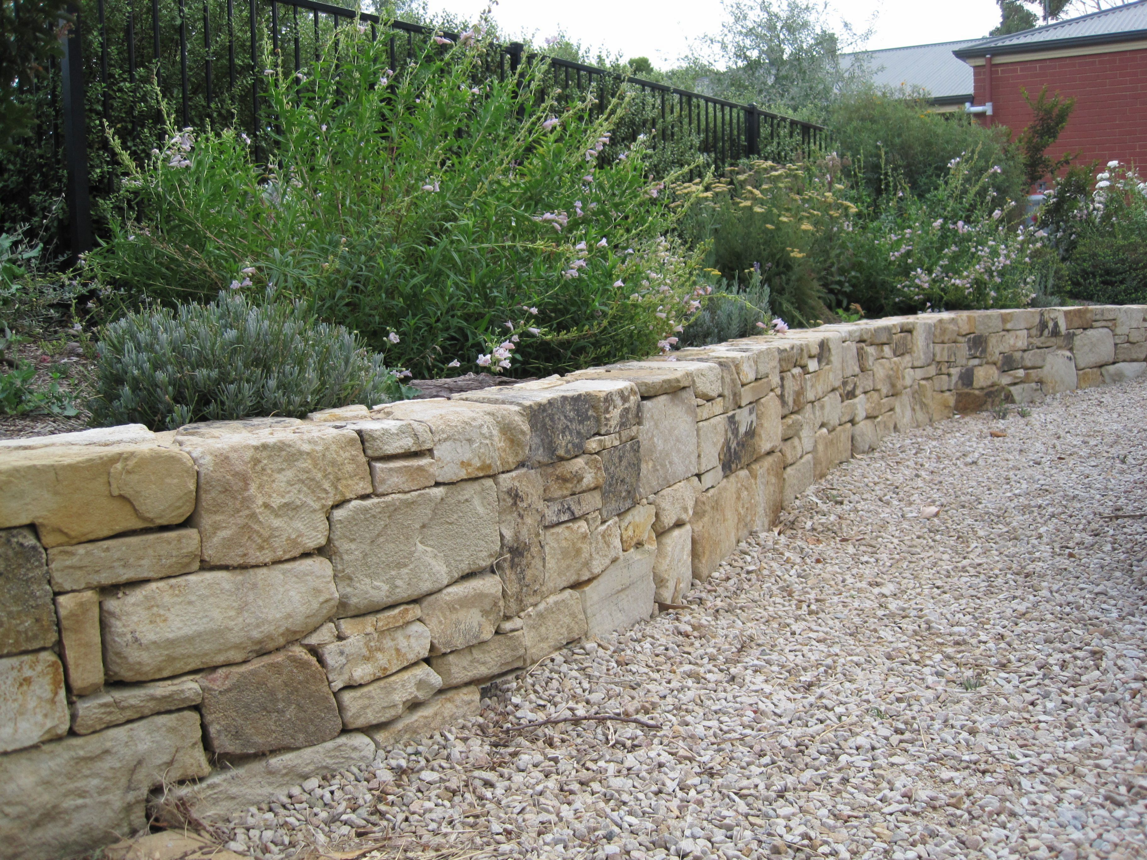 Concrete block wall with finished grading and landscape tiers