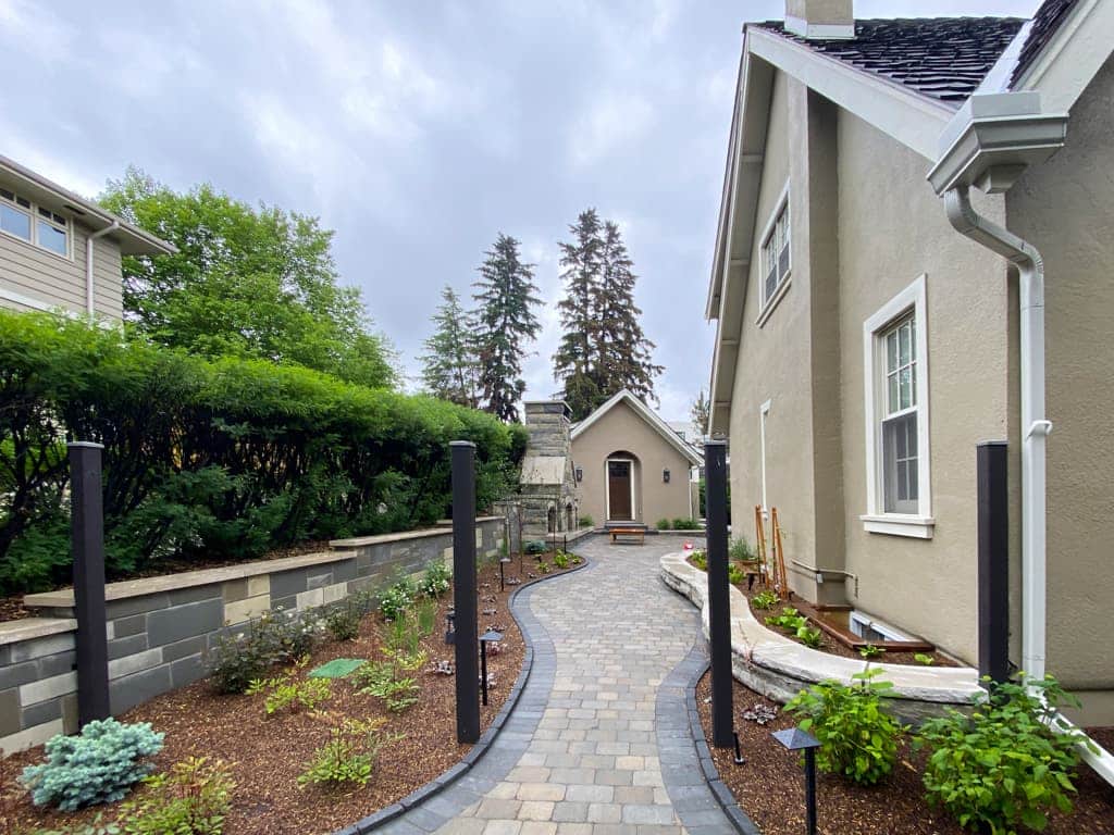Interlocking paver walkway through landscaped yard