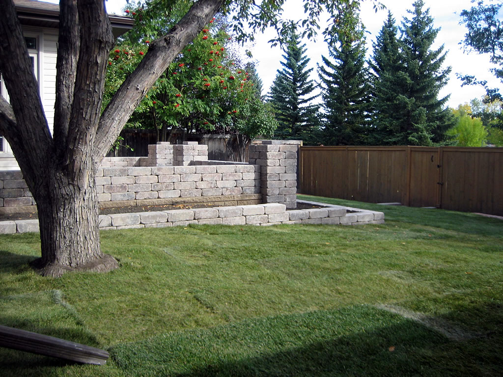 Retaining wall contractor Calgary project on a sloped property